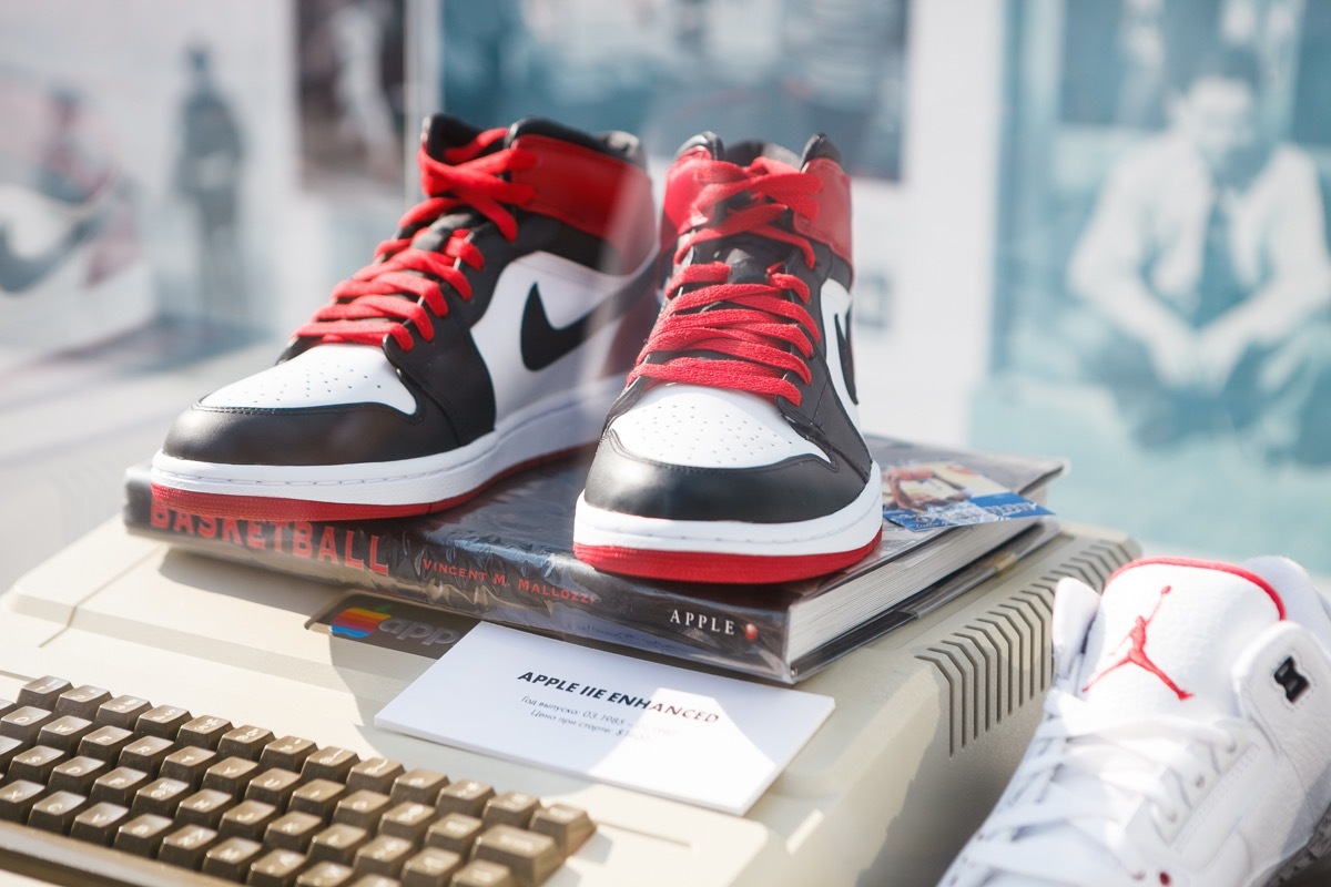 MOSCOW-6 AUGUST, 2016:Rare Nike Air Force 1 basketball sneakers in black, white & red colors.Nike basketball fashion shoes on stand at fashion exposition.Fashionable foot wear for youth & Apple II pc - Image