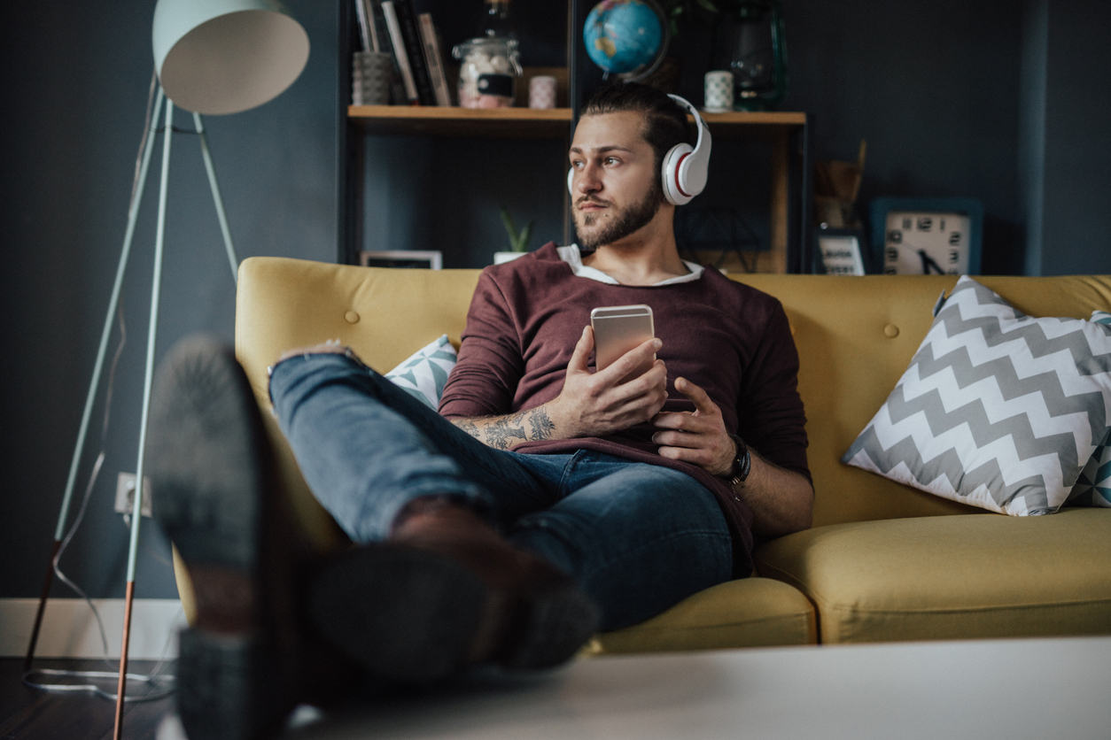 young man relaxing and listening to music