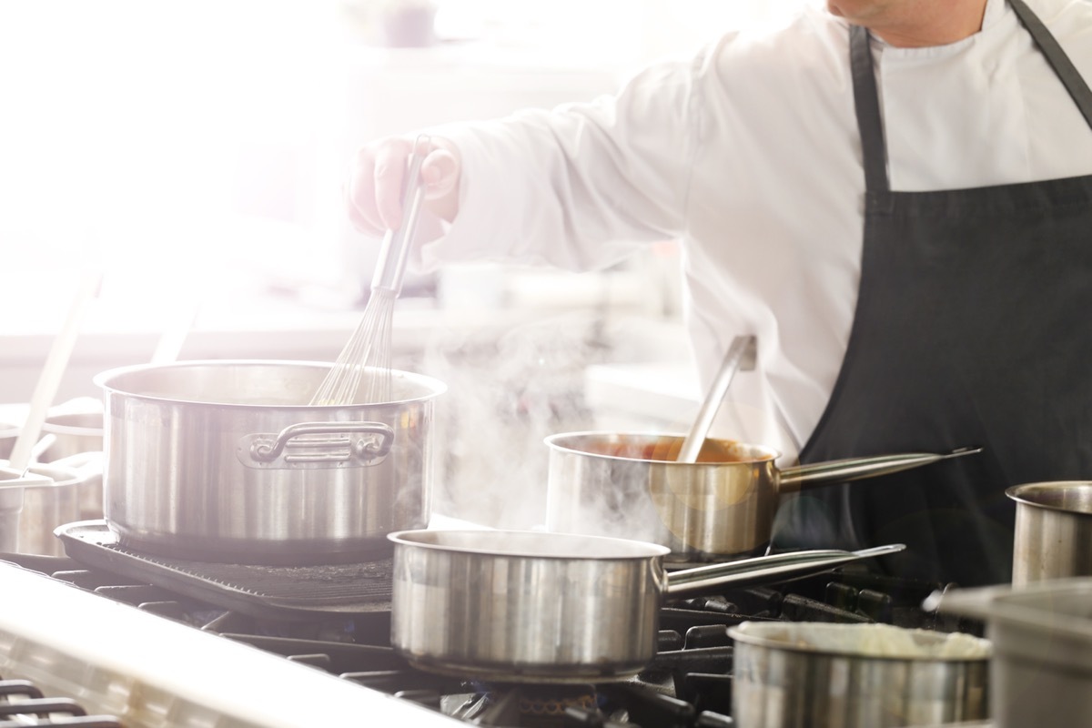 chef cooking on gas stove