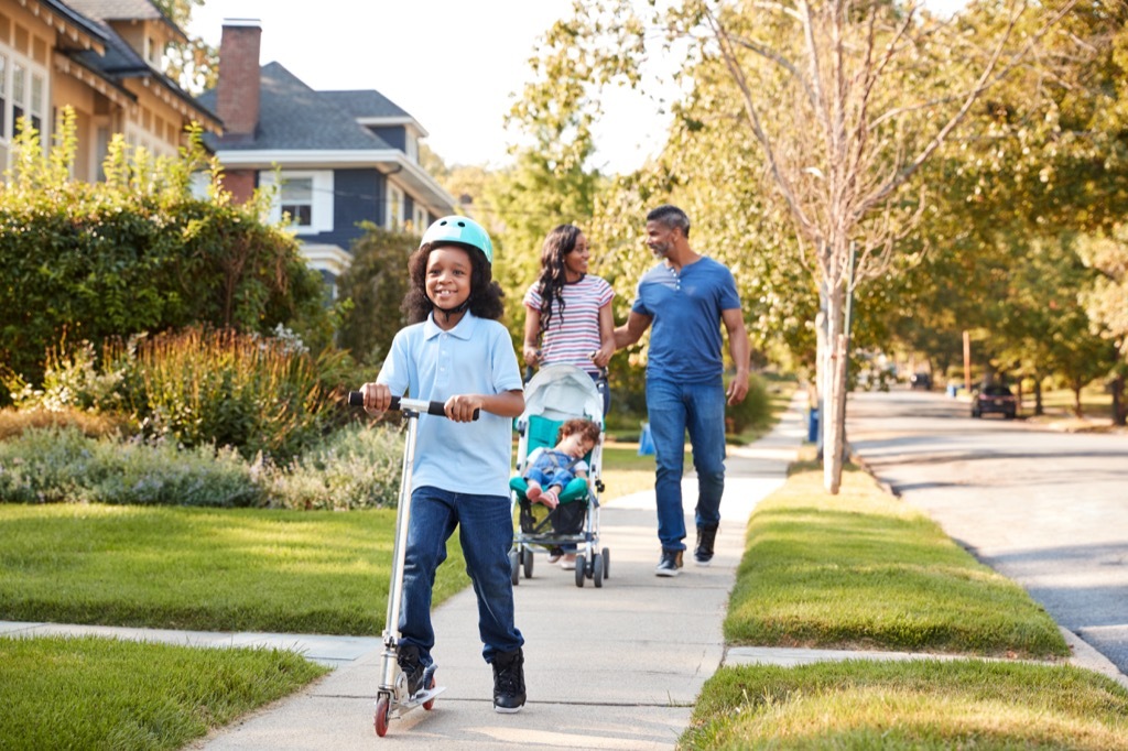 family walking on a sidewalk