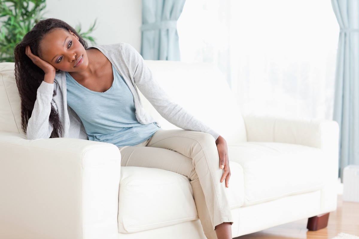 Woman using a couch armrest