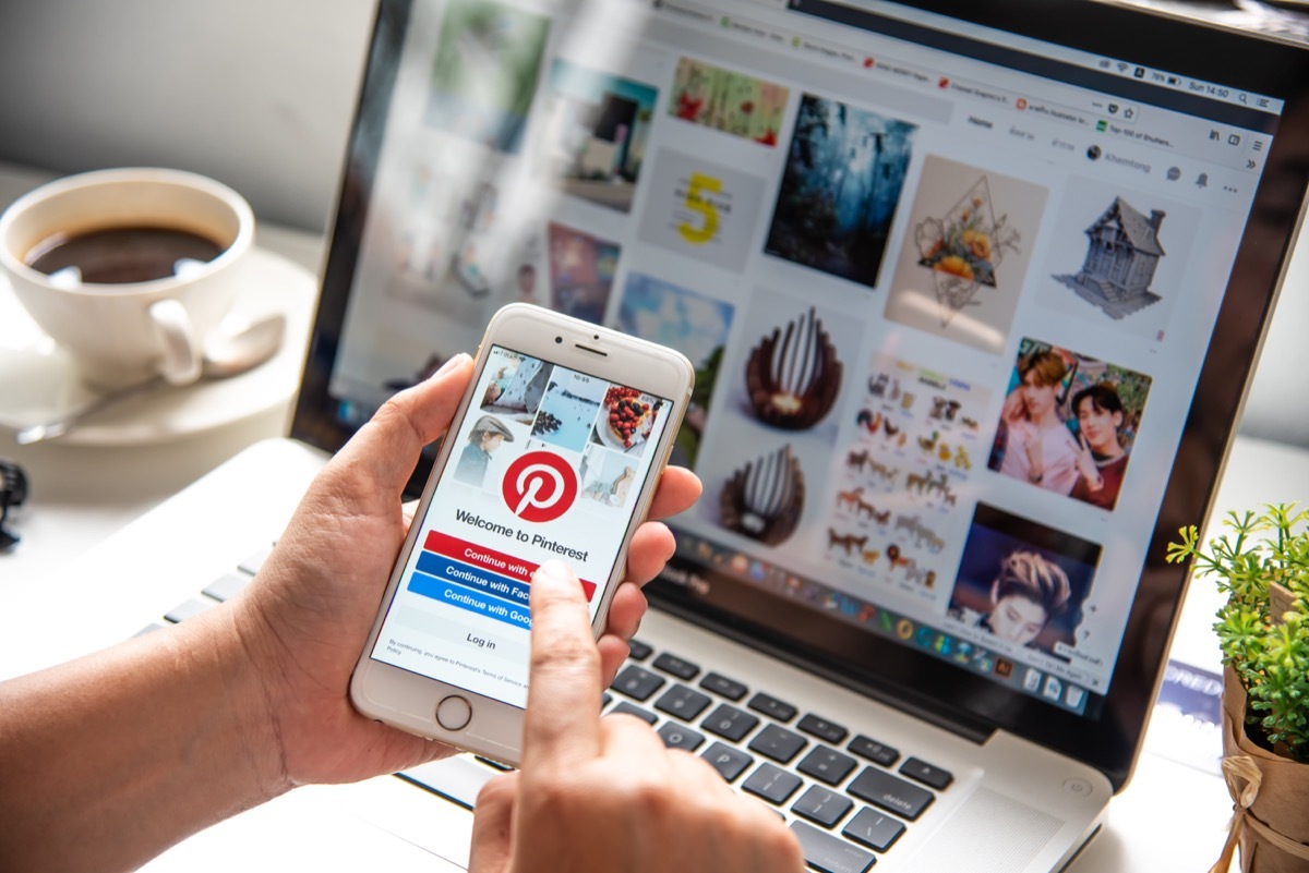 Person doing Pinterest research on a computer and phone