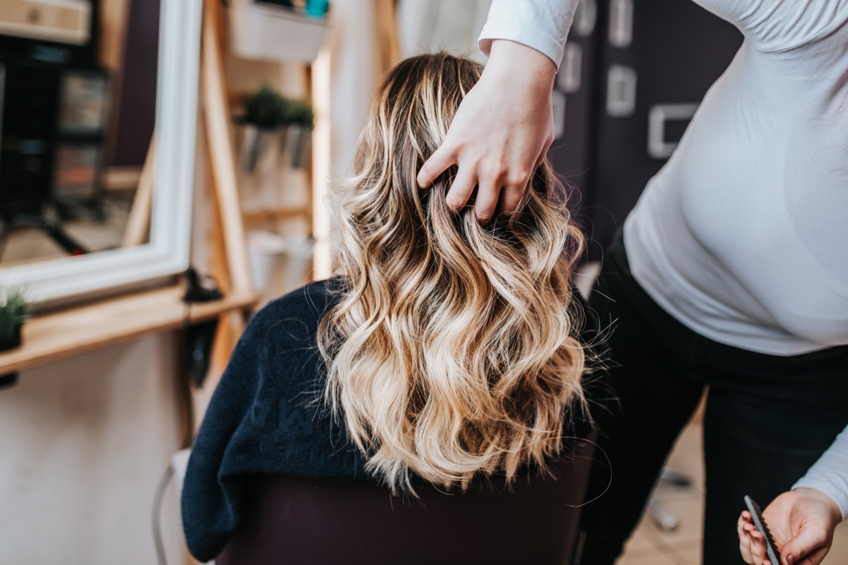 Woman getting her hair done at hair salon.