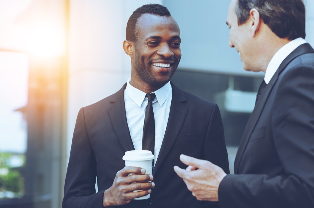 man talking to friend ways to get a promotion after 40