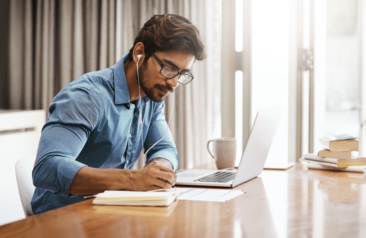 Cropped shot of a handsome young businessman working on his laptop in the office at home