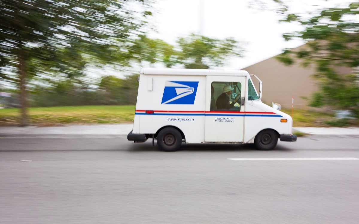 United States Post Office mail truck (USPS) speeding in Miami, Florida - motion blur panning.