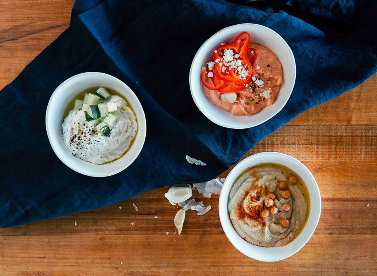 trio of greek dips with yogurt sauce hummus and red pepper dip