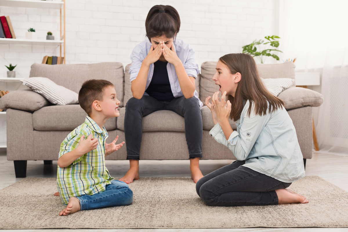 Mom is stressed by screaming children fighting with each other