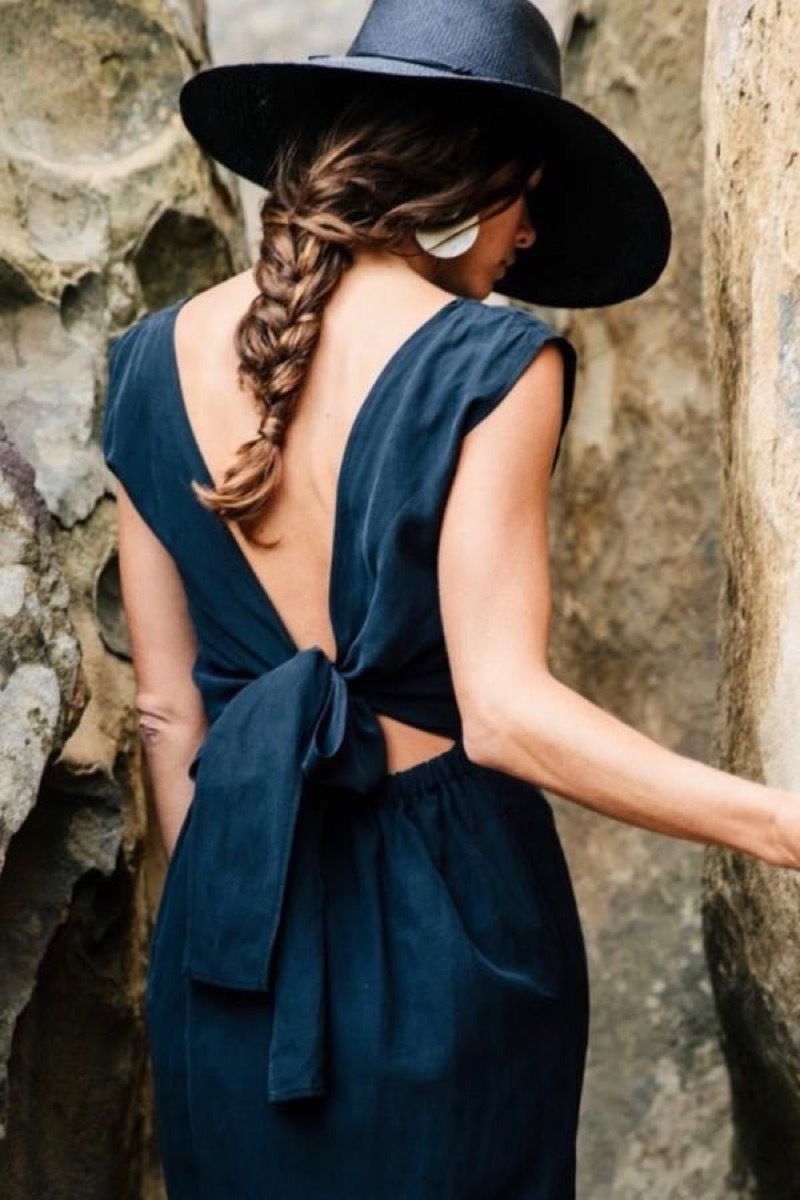 white woman in blue dress and hat