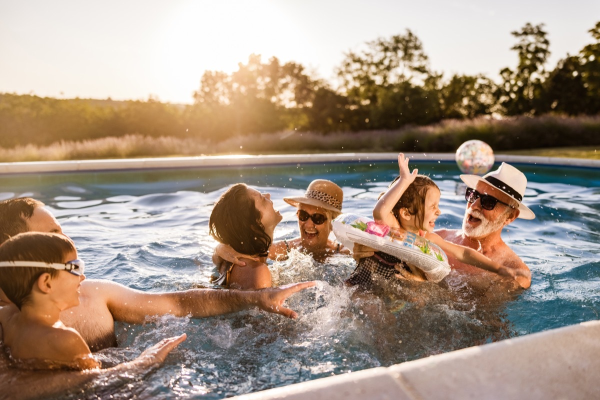 family having fun during summer day in the pool.