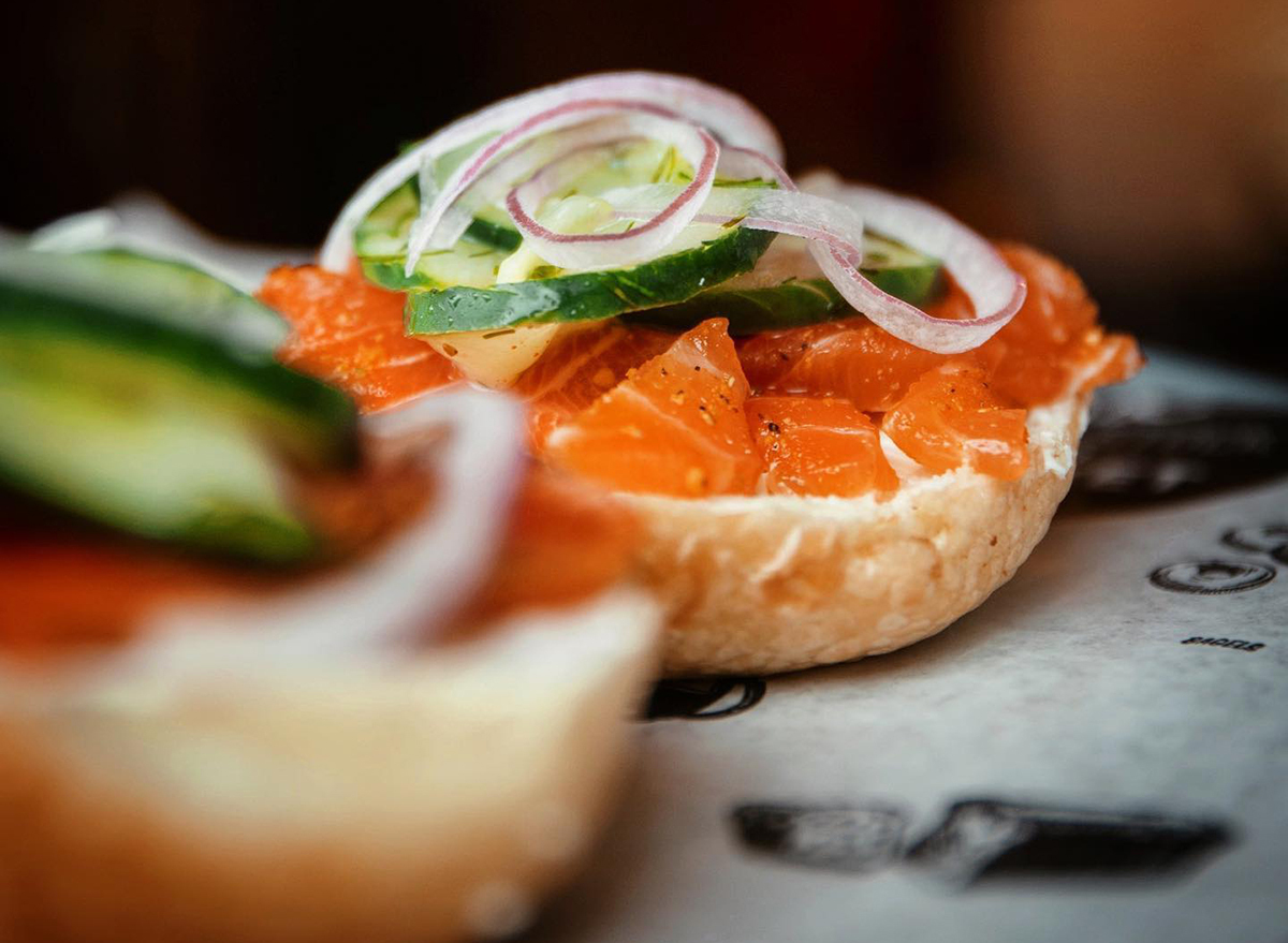 bagel topped with lox and vegetables