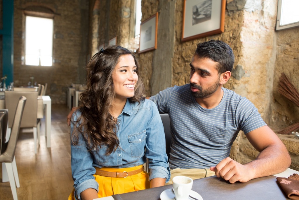 young couple sitting at a restaurant, open marriage