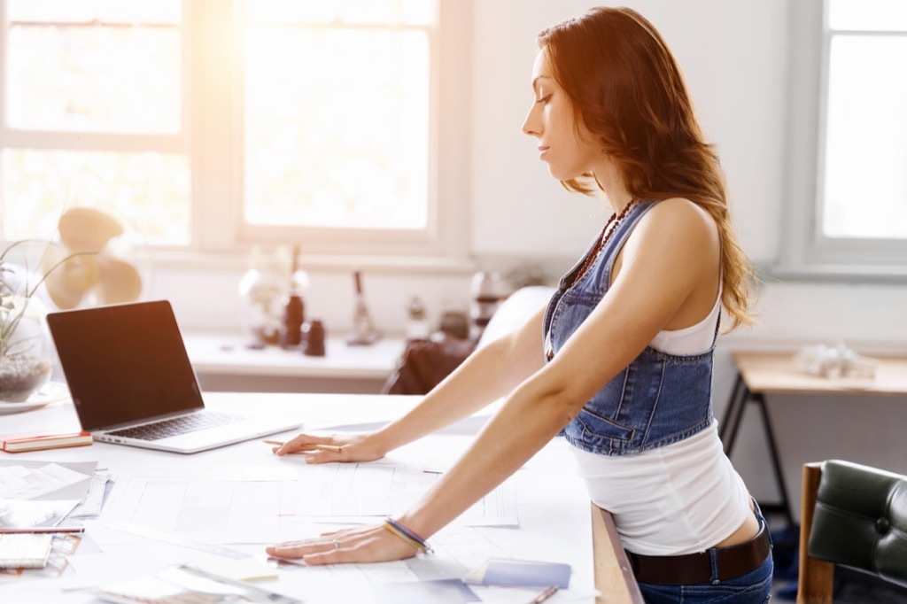 Woman at Standing Desk Craziest Corporate Policies