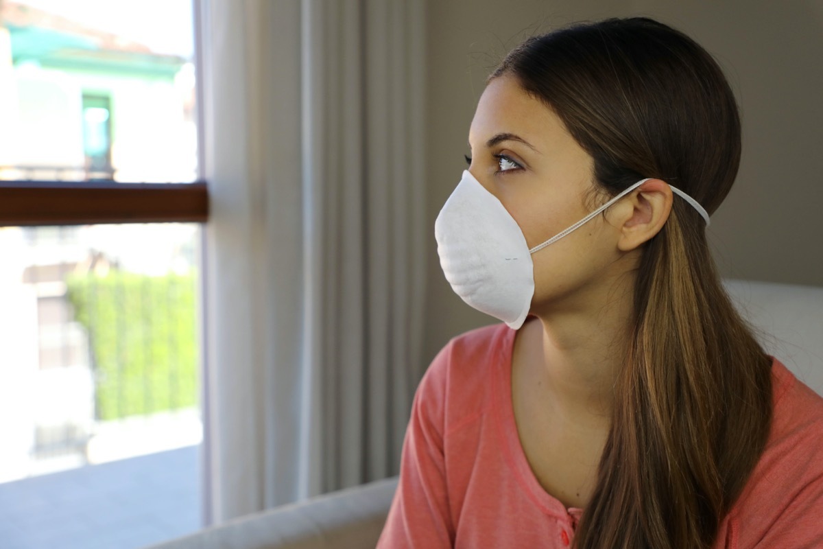 Woman at home wearing face mask.