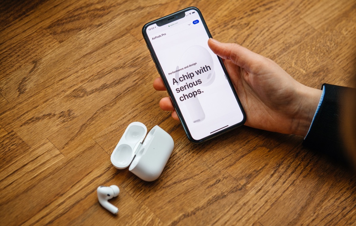 Paris, France - Oct 30, 2019: Overhead view of woman hands unboxing new Apple Computers AirPods Pro headphones with Active Noise Cancellation for immersive sound - a chip with serious chops