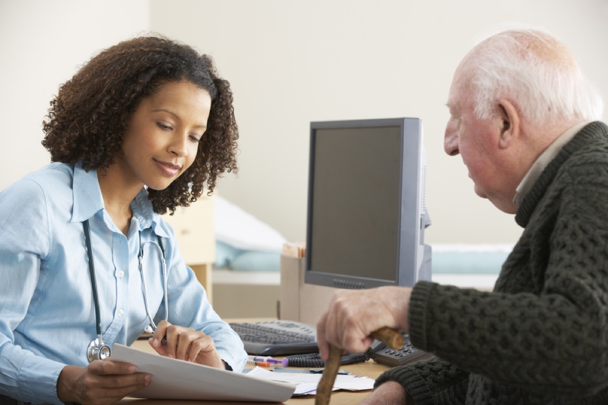 young black female doctor speaking to older white male patient, heart risk factors