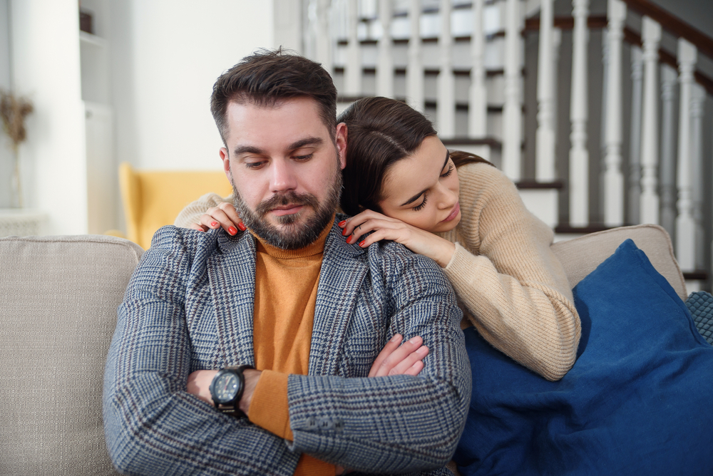 Clingy woman apologizing to boyfriend or husband