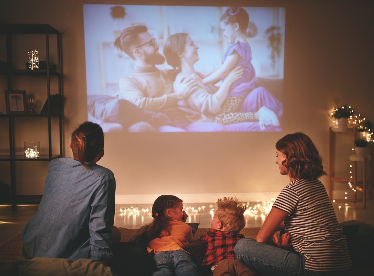 Family watching projector at home