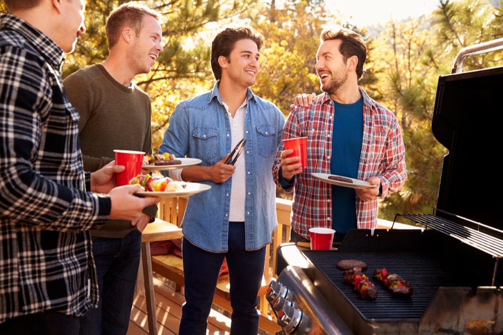 men grilling together