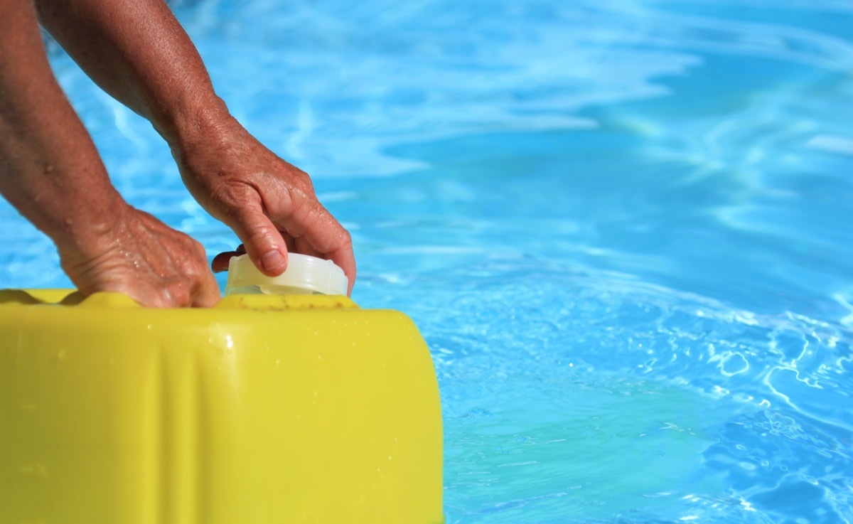 someone putting chlorine in a pool