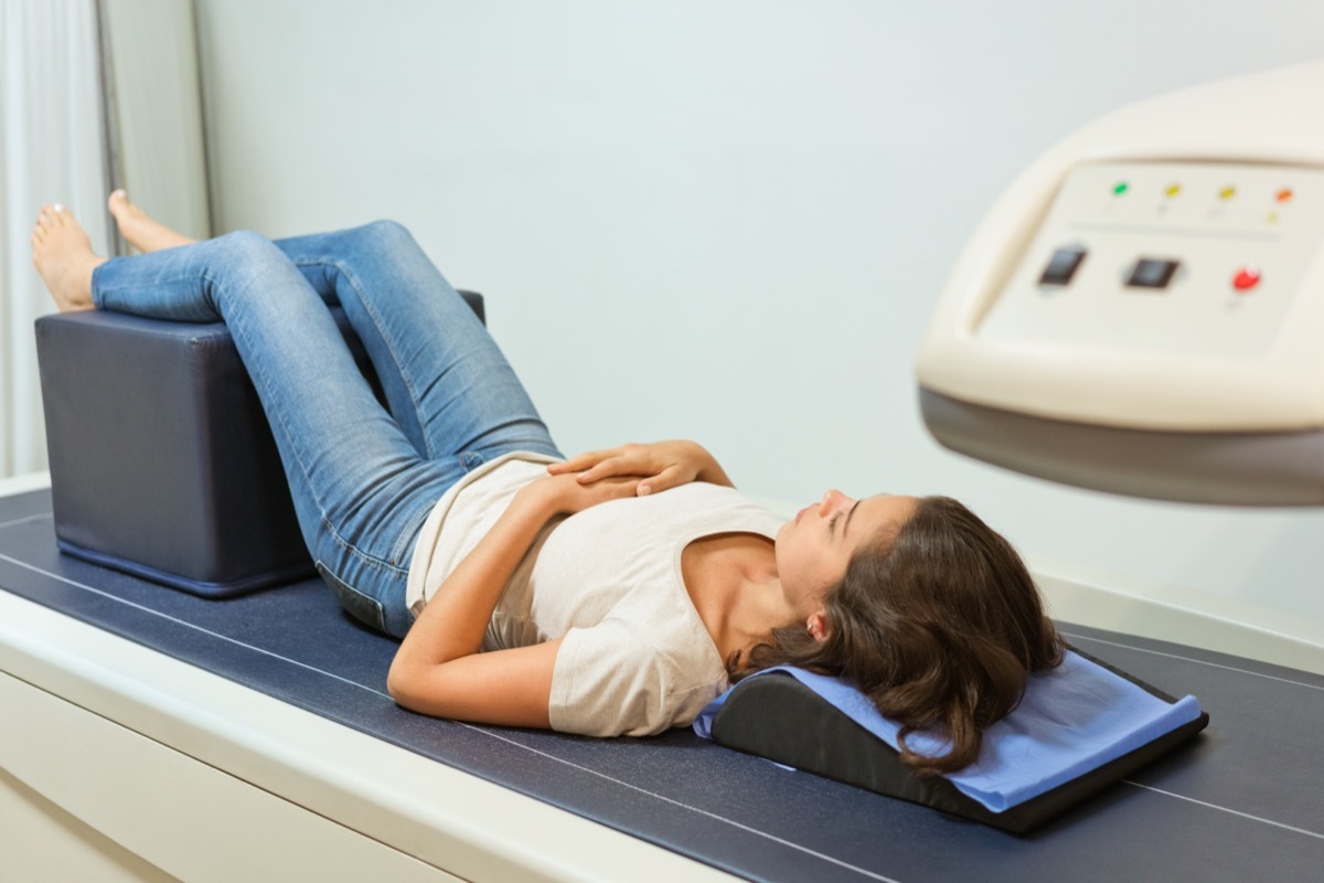 Woman going through bone density exam.