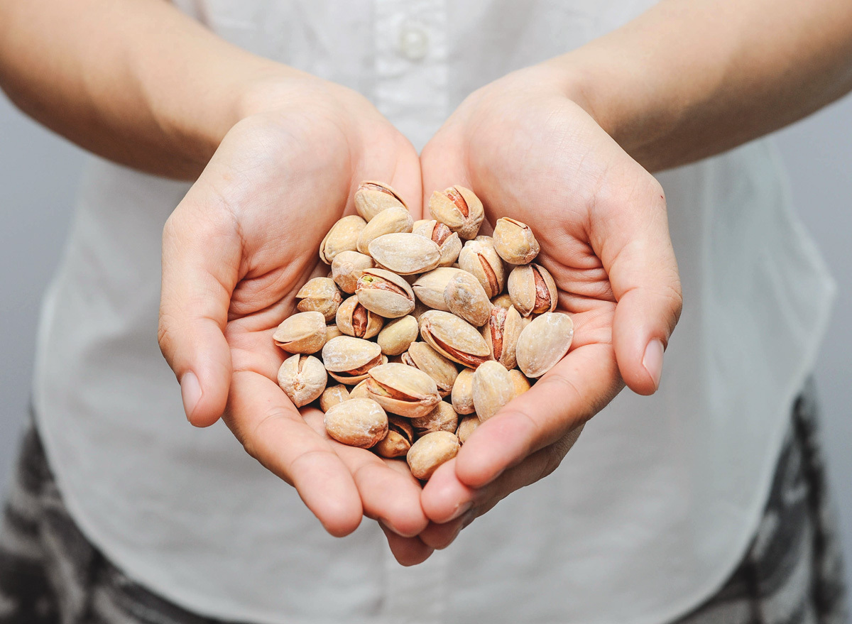 Holding pistachio snack in hands