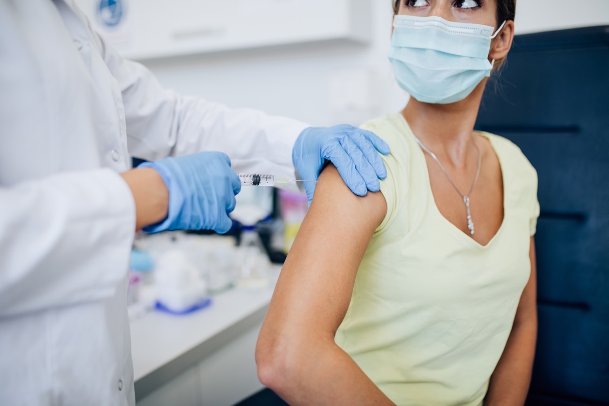 a woman receives COVID vaccine