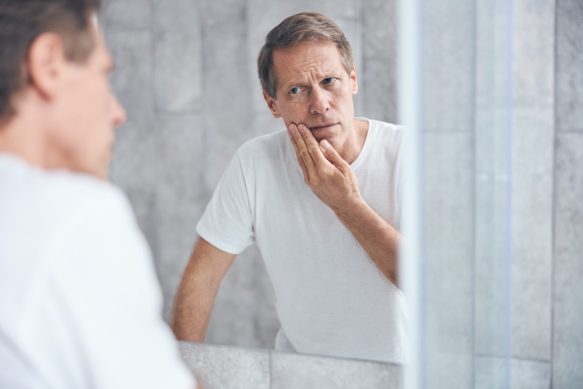 man looking in mirror