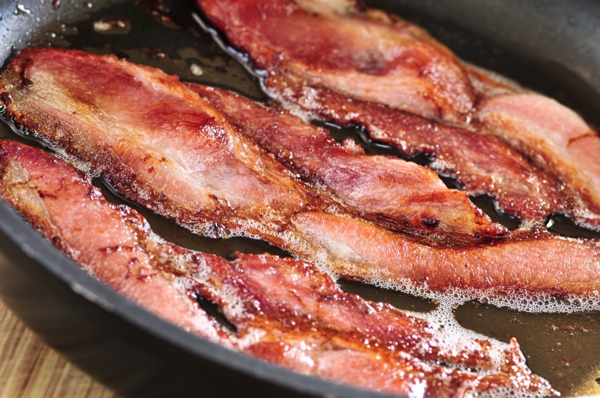 bacon cooking in a cast iron skillet