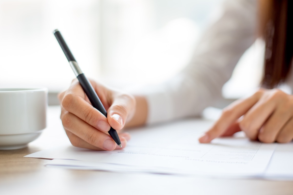 woman reading document and scanning for specific words with finger