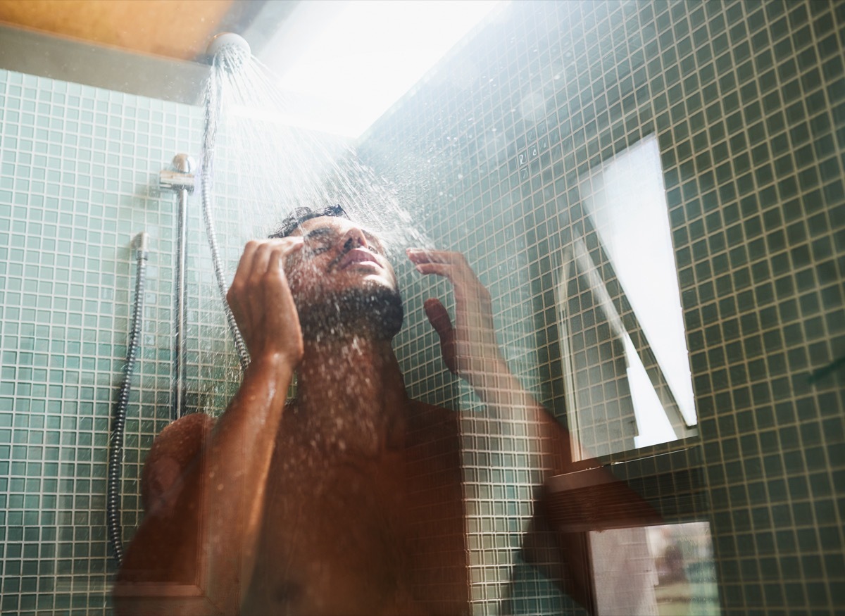 Cropped shot of a handsome young man having a refreshing shower at home