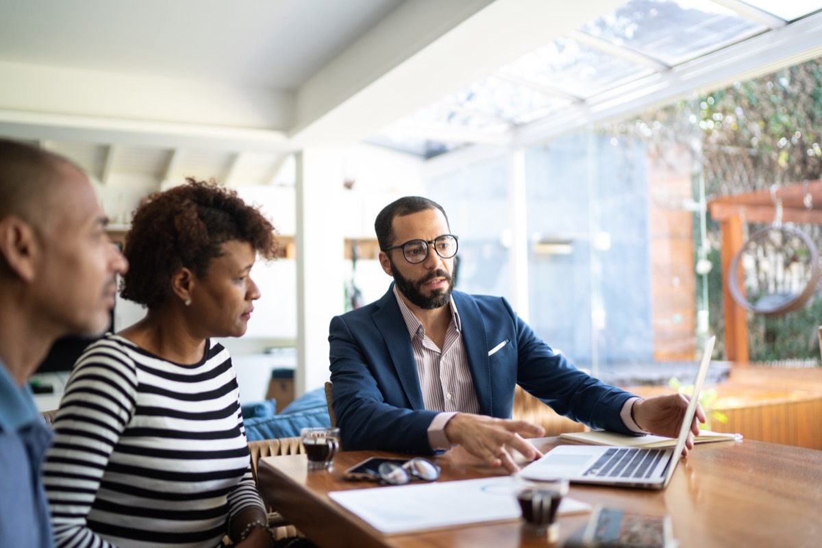 Couple talking to finance advisor at home