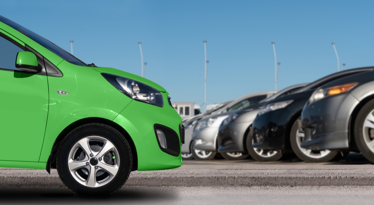 green car in a parking lot