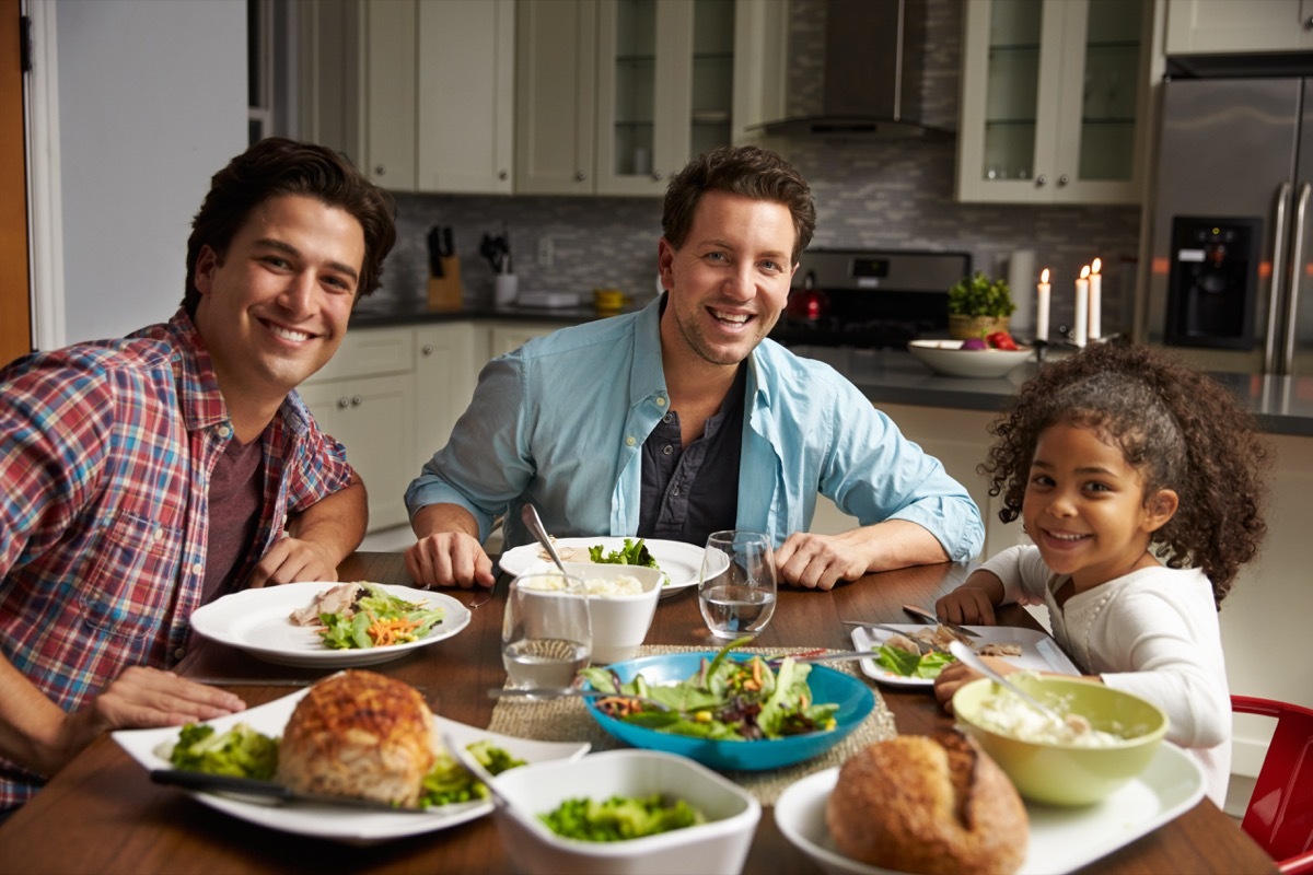 daughter with two fathers at dinner table