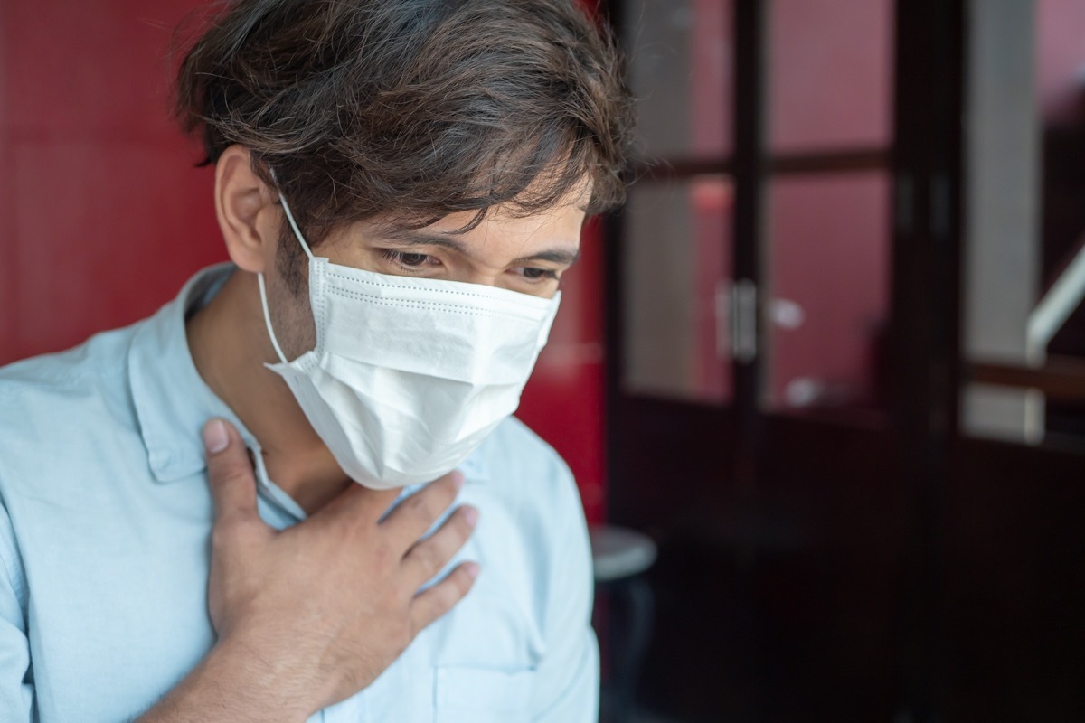 man wearing air filter mask having Dyspnea, breathing difficulty, respiratory distress in unhealthy, danger, polluted air environment