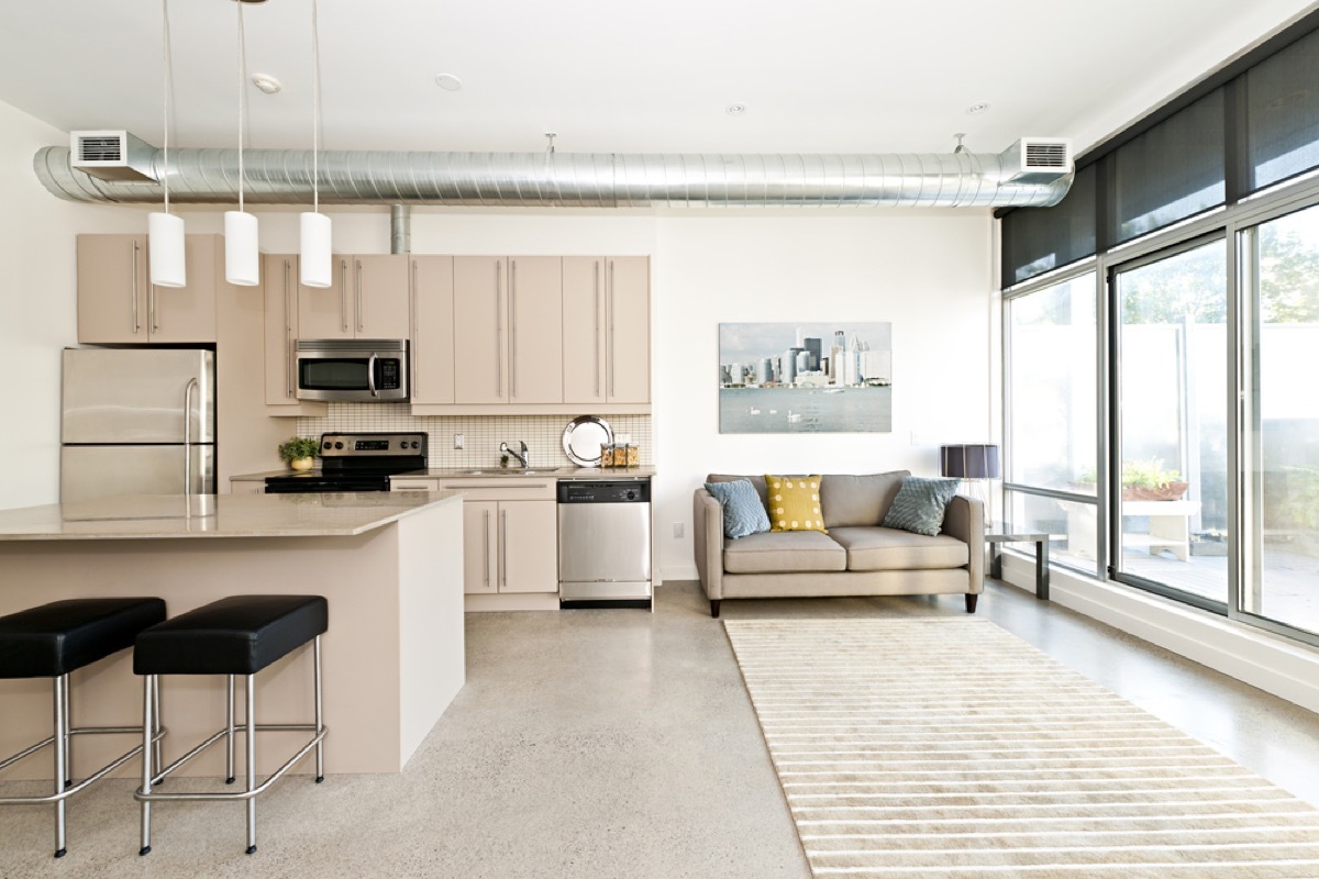 living room with concrete flooring, vintage home upgrades