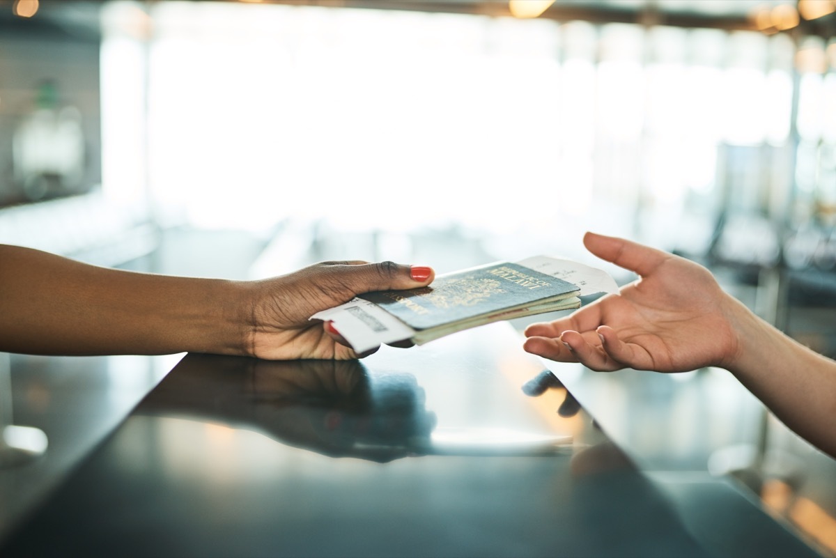 handing passport over airport service counter