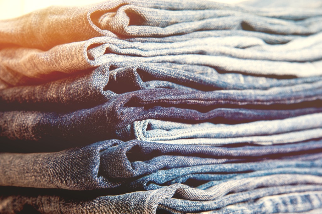 stack of blue denim jeans - how to dress over 50 