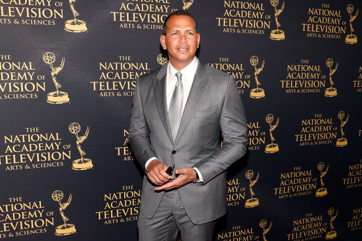 alex rodriguez in silver suit in front of step and repeat