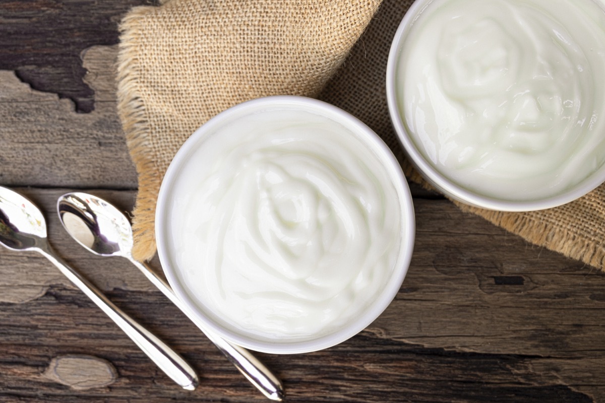 Yogurt In white glass wood background from top view.