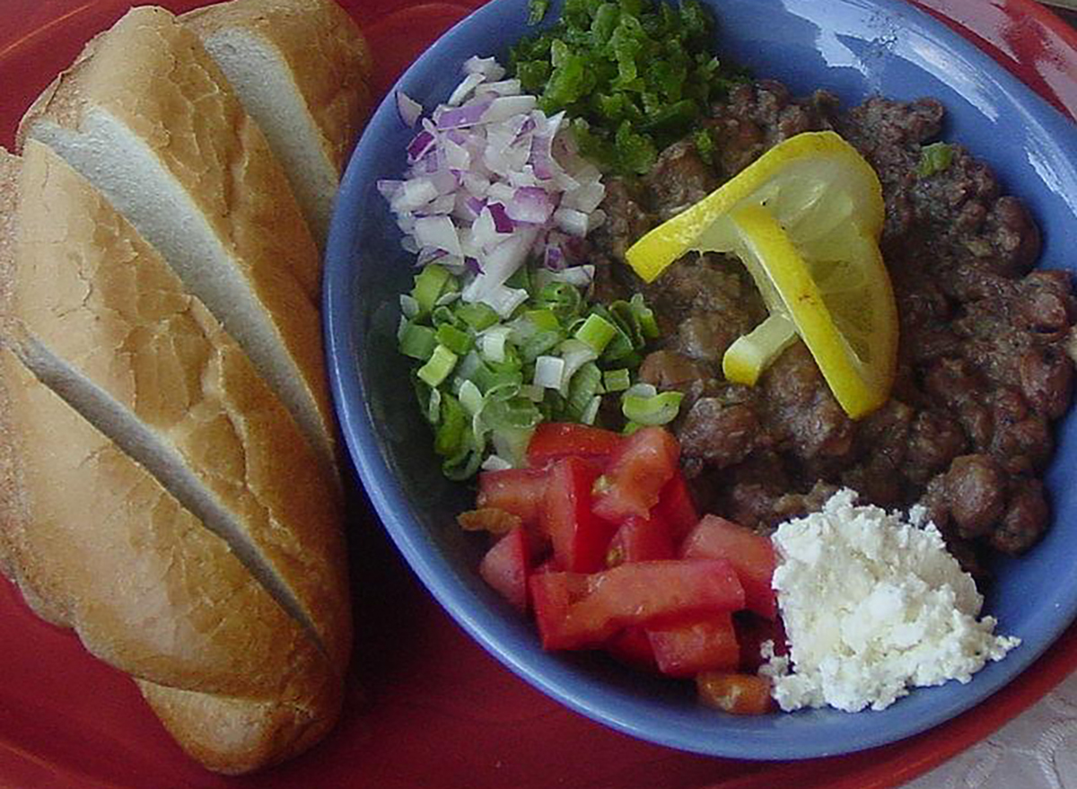 bowl of meat and vegetables with sliced bread