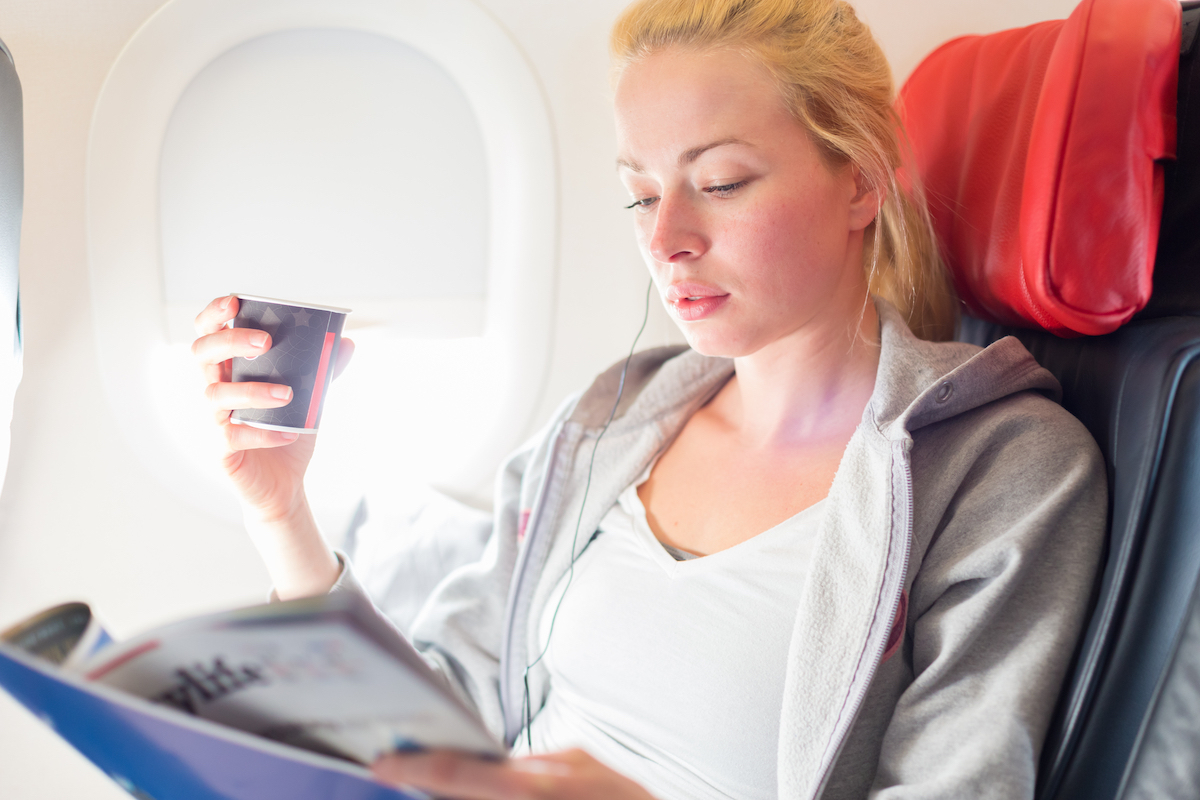 woman drinking on plane