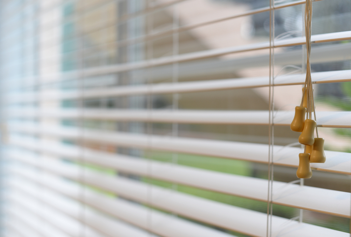 Close-up of a window blinds, Room white curtain catching the sunlight 