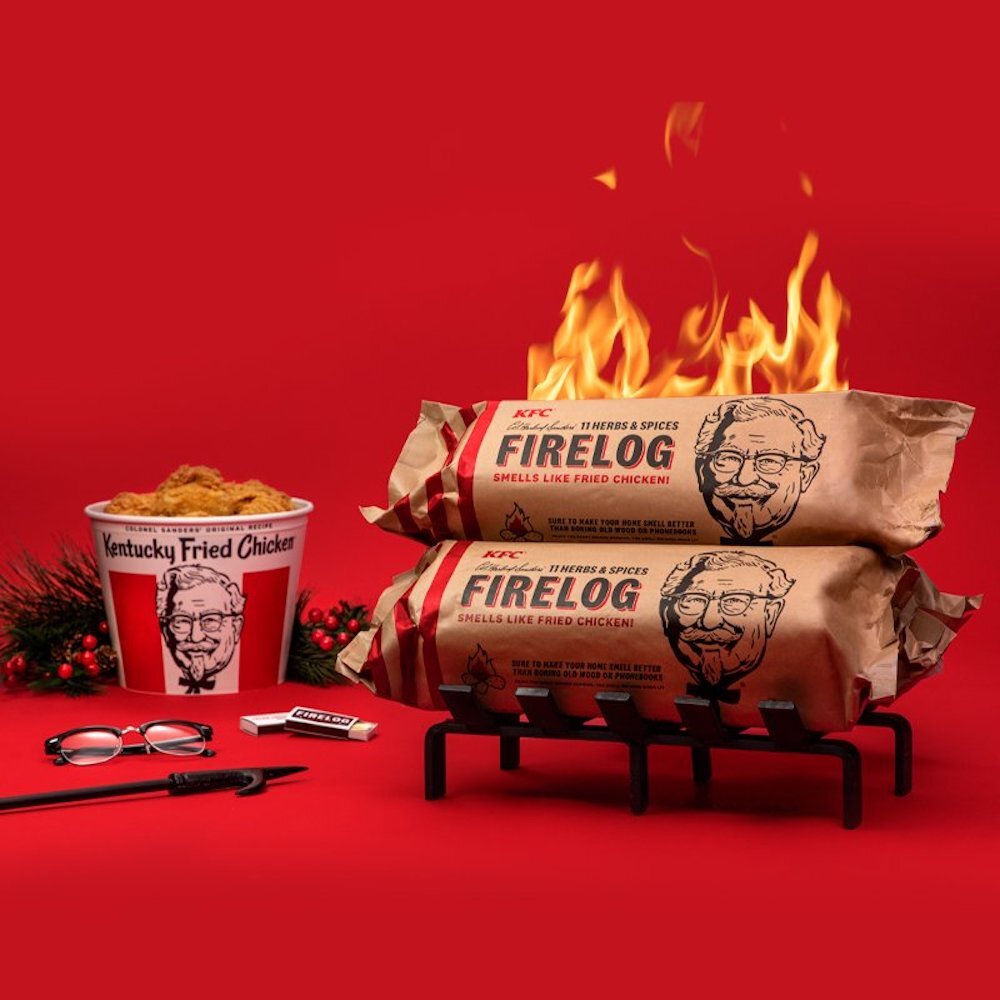 KFC firelog burning on red background next to a bucket of KFC chicken