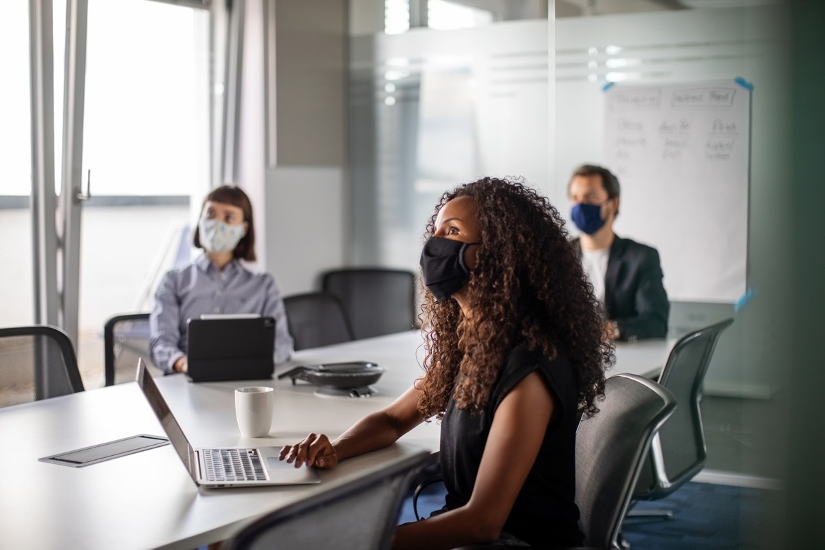 people in an office wearing masks