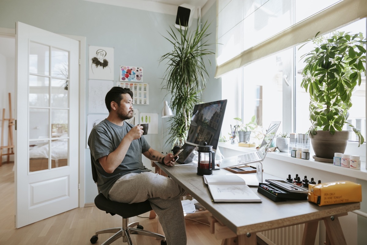 digital artist at his home studio taking a coffee break.