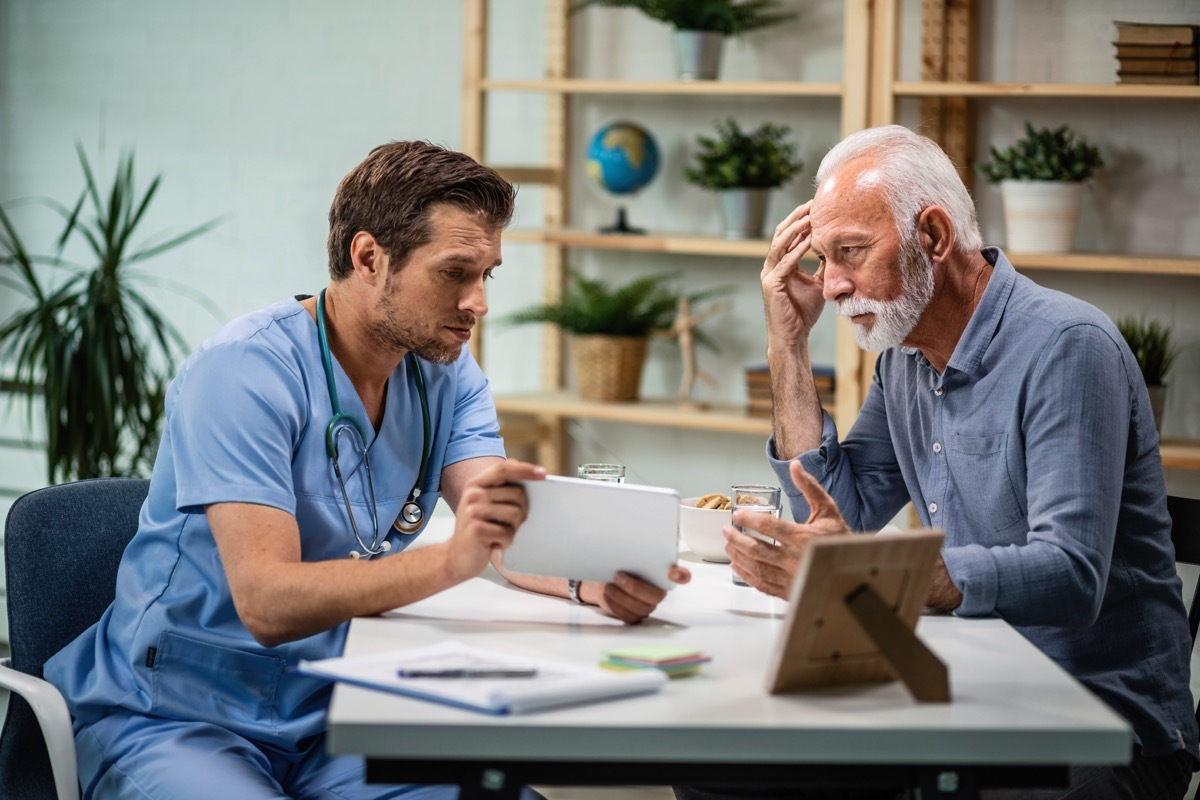 doctor showing patient results but not making eye contact