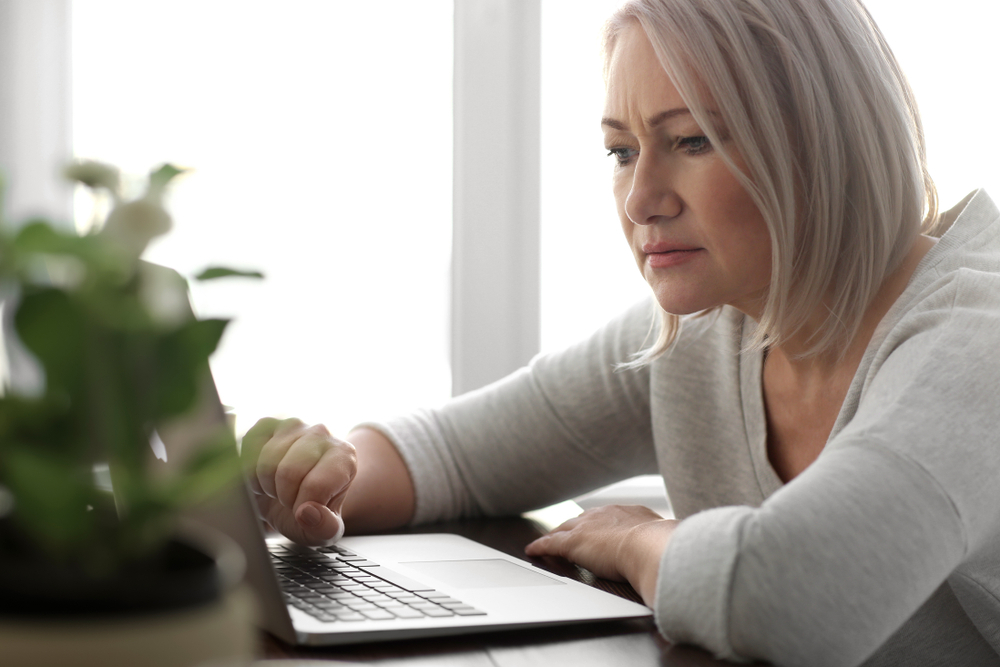 senior woman staring at laptop