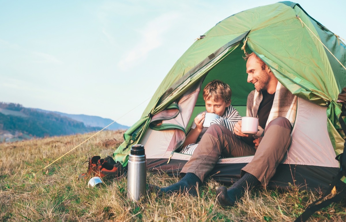 Father son camping in tent