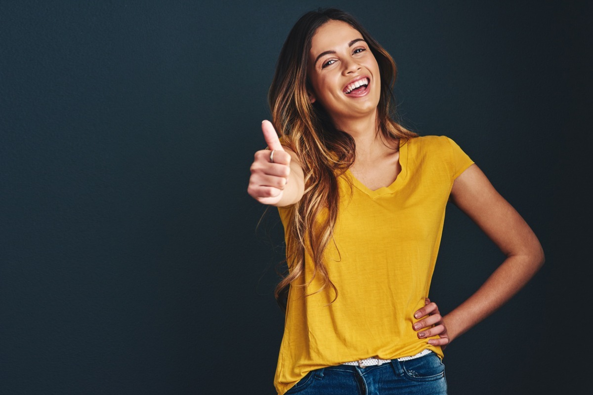 young woman giving thumbs up